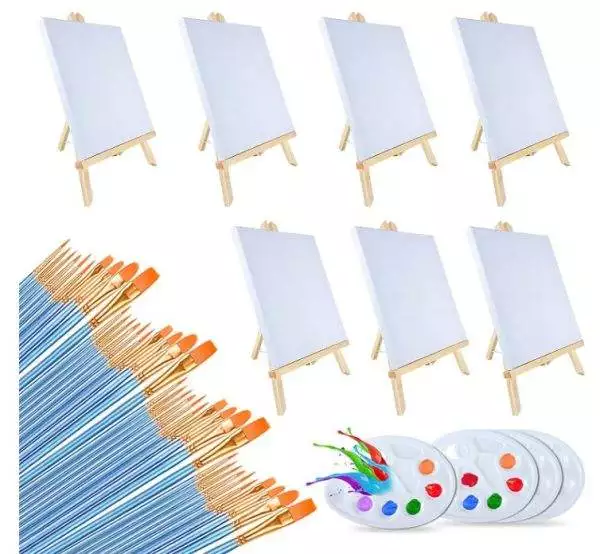 Image of the Painting Party Kit, featuring six blank canvases on wooden easels, approximately 24 blue-handled paint brushes with orange tips, and three plastic paint palettes filled with various colors—perfect for a kids party rental or an artistic slumber party.