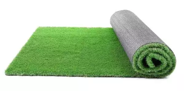 A rolled-out section of the Grass Rug Add-on, perfect for any slime party, partially unrolled to show the green fibers on one end and the gray backing on the other.