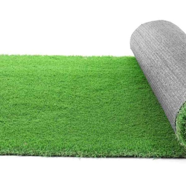 A rolled-out section of the Grass Rug Add-on, perfect for any slime party, partially unrolled to show the green fibers on one end and the gray backing on the other.
