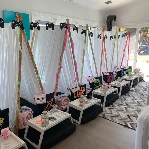 Host an unforgettable Minecraft-themed sleepover with individual tents, decorated tables, and gaming-themed accessories like Minecraft character pillows and pixelated designs. Perfect for a slime party or consider using a kids party rental service to make it hassle-free!