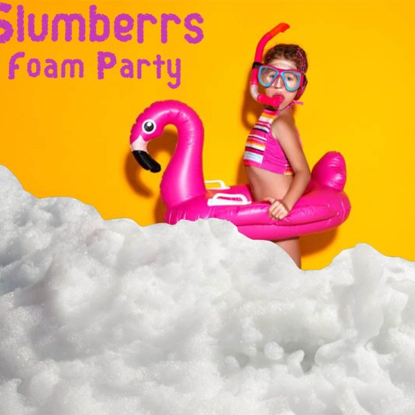 A person wearing a snorkel, mask, and swimwear stands in a foam party. They have a pink flamingo float and the background is yellow. Text reads "Slumberrs Foam Party—perfect for your next kids party rental!