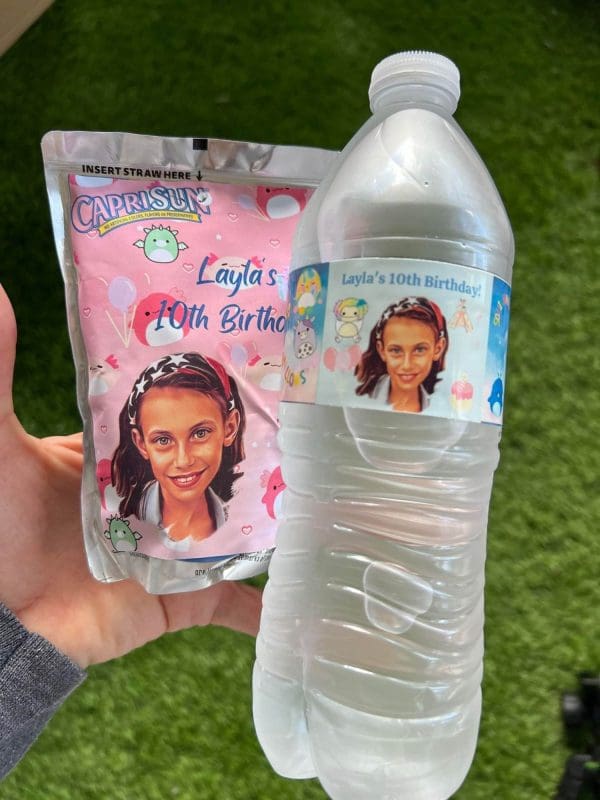 A hand holding a Capri Sun pouch and water bottle, both customized with a girl's photo and "Layla's 10th birthday" labels, perfect as party upgrades.
