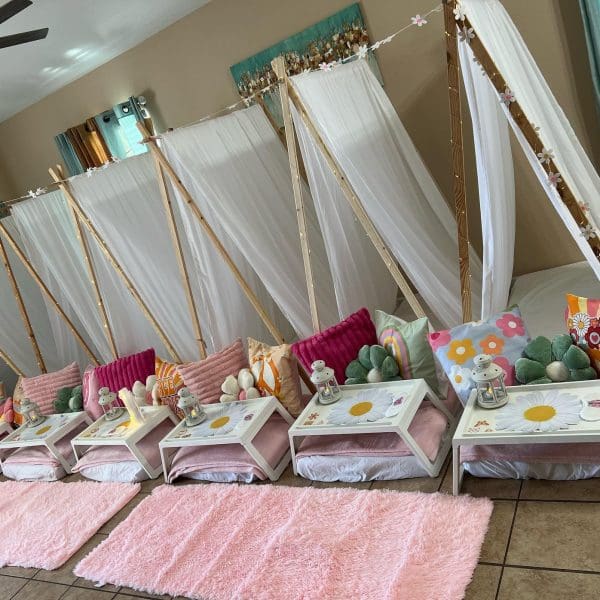Indoor Slumber Party Tampa Fl setup with teepees, fur rugs, and decorated trays arranged on the floor.