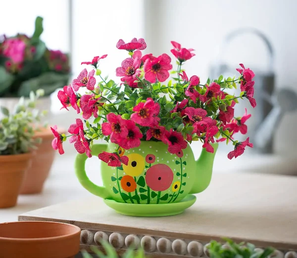 Bright pink flowers blooming in a green, owl-themed **Painting Party** on a kitchen counter during a creative event.