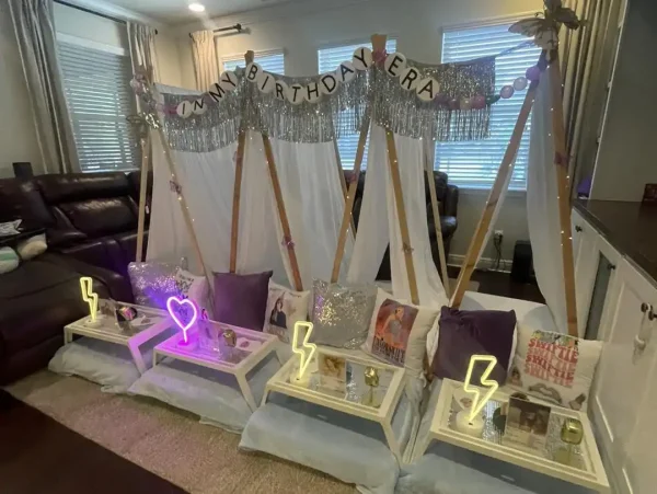 Three indoor tents with decorative banners reading "in my birthday era" are set up in a room. Each tent has a tray with light-up decorations, pillows, and a touch of the Taylor Swift Theme.